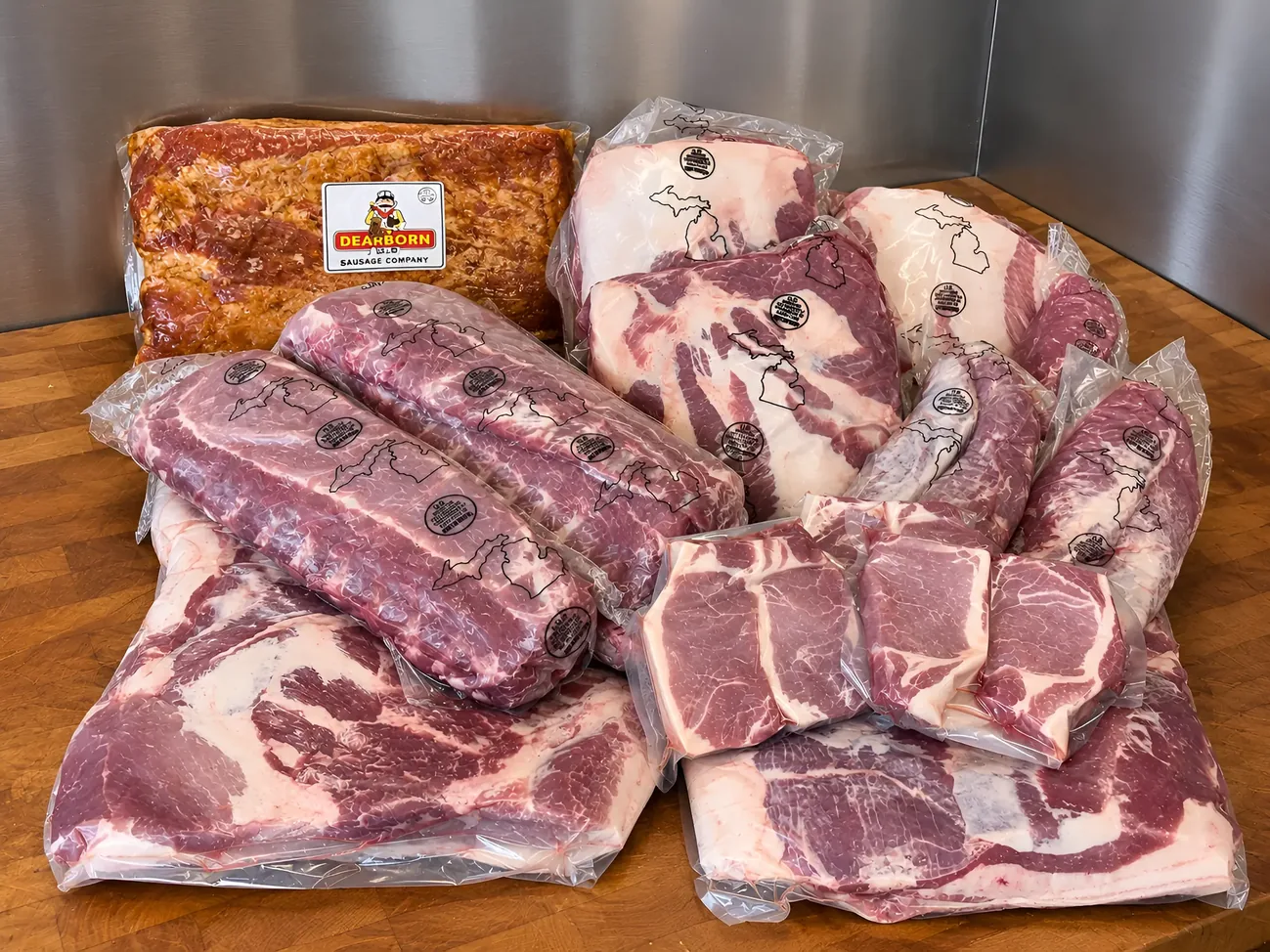 Michigan pork cuts laid out on a wood table at Plymouth Prime Meats