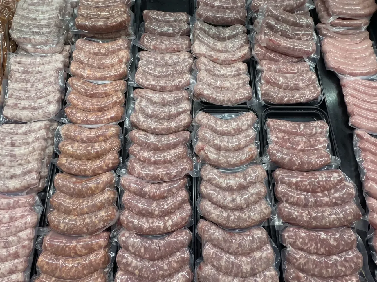 Rows of house-made sausage links in the Plymouth Prime Meats case